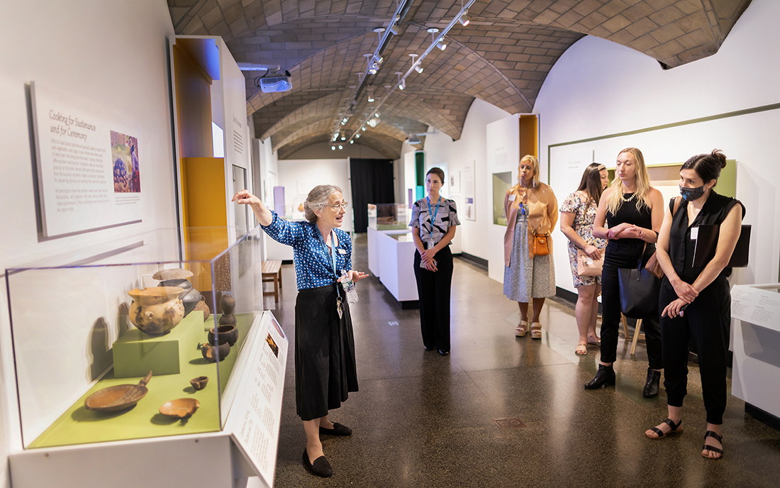 Museum visitors being shown around the Ancient Food and Flavor exhibit.