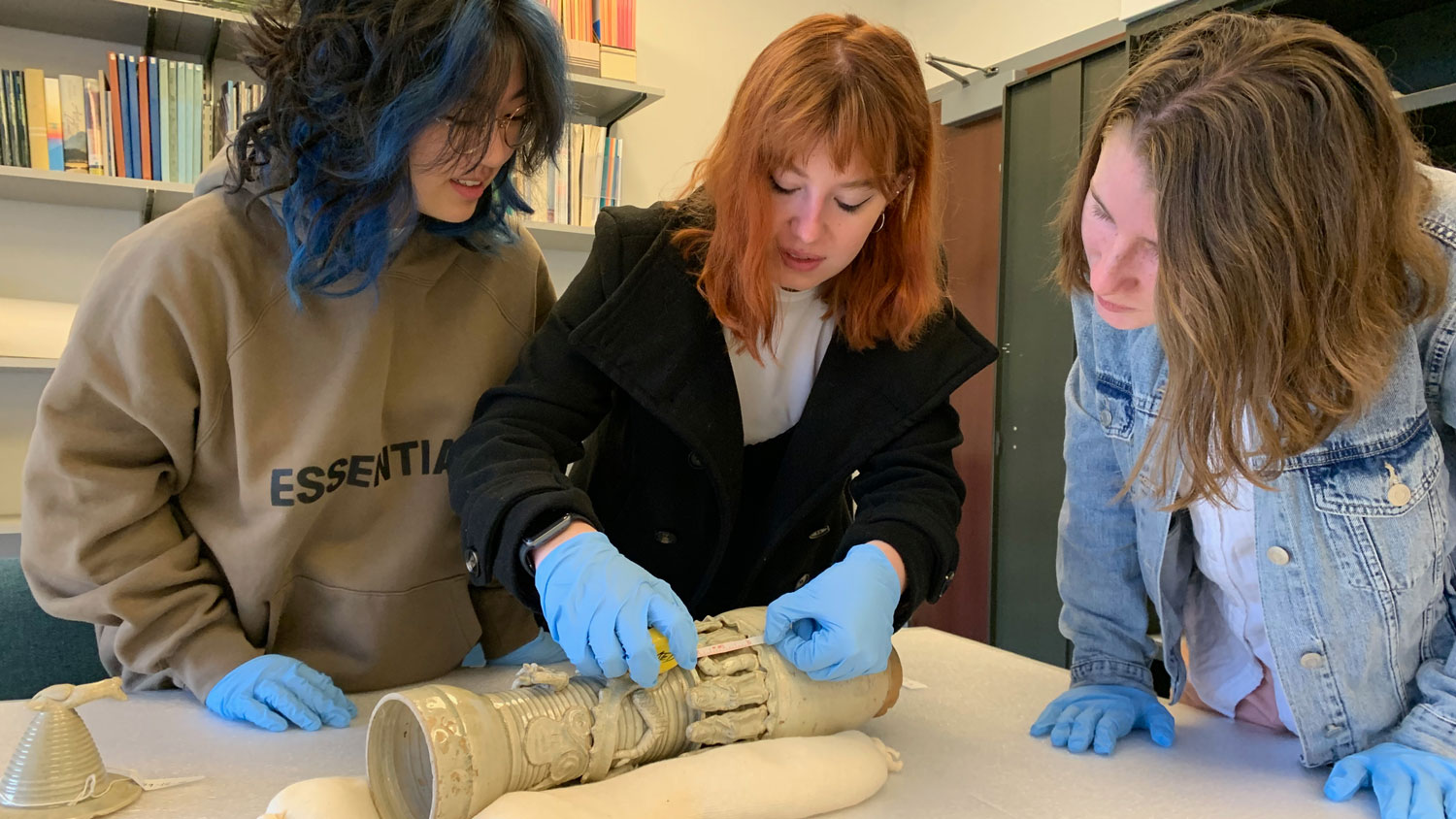 Student curators examining an artifact.