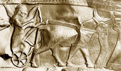 Closeup of a gold bowl detailing a weather god.